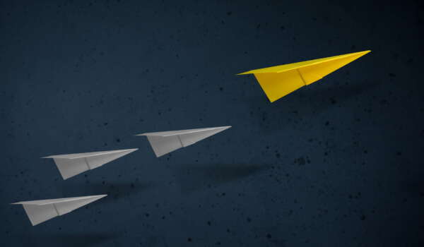 Leadership Concept. Unique Paper Plane Leading the other. Goals and Success in Business