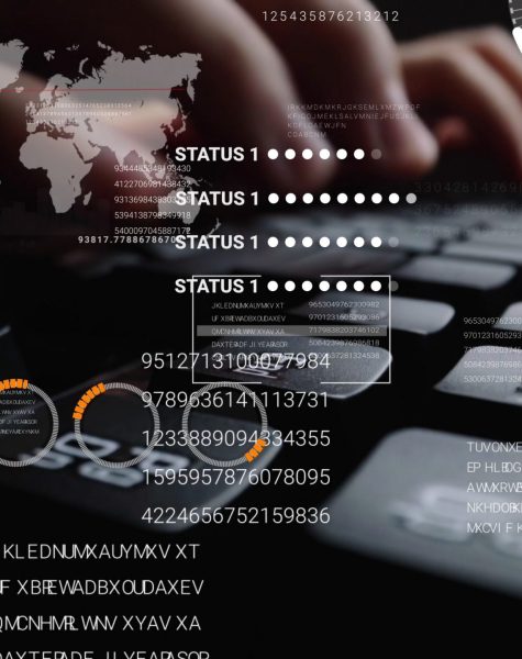 Man working on laptop computer keyboard with graphic user interf